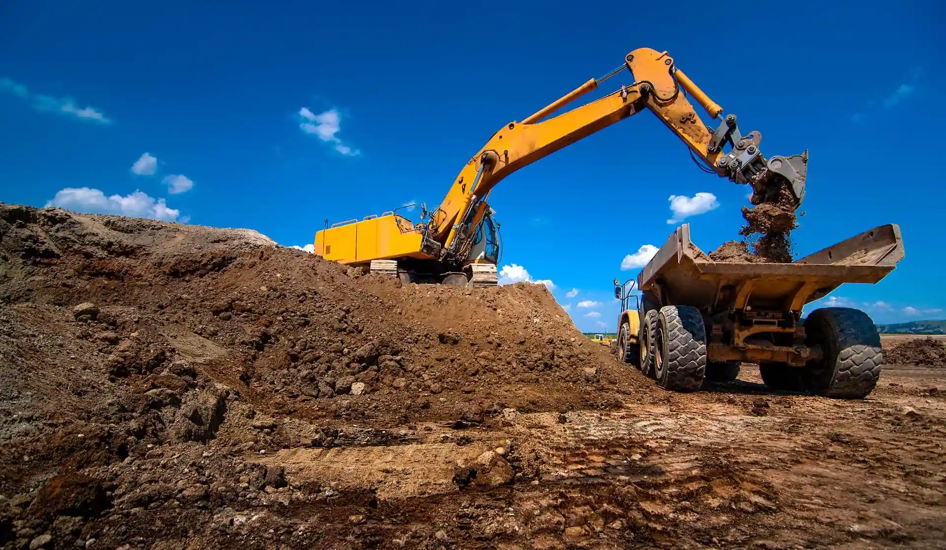Dump truck being filled with dirt